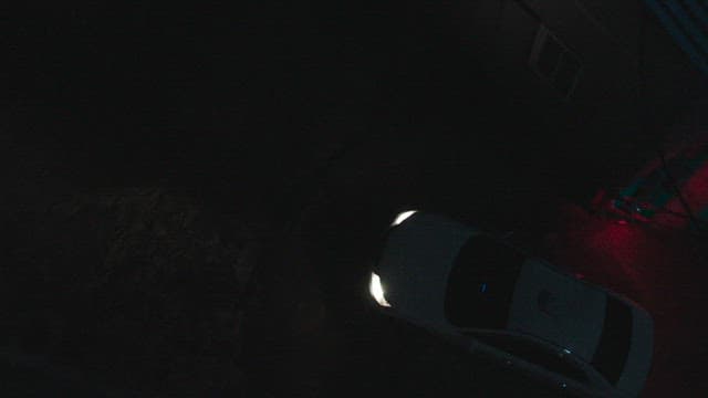 Taxi moving in a wide open space in the dark of night