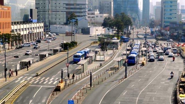 Busy city road with multiple buses and cars