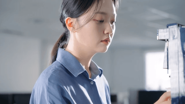Woman making coffee from office coffee machine
