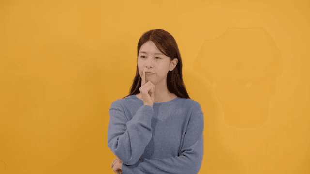 Woman lost in thought, resting her finger on her chin