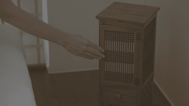 Person opening and lightning a wooden lamp