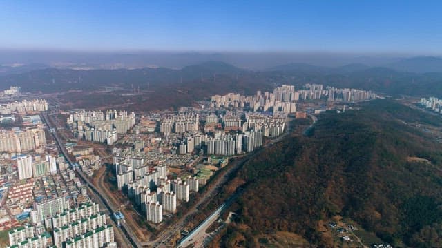 Residential City Formed at the Foot of a Lush Mountain