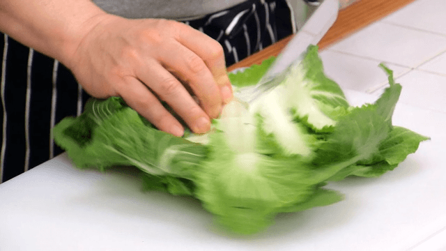 Chopping fresh spring cabbage on a cutting board