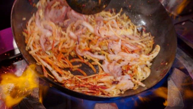 Stir-frying in a flaming wok at high heat