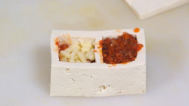 Tofu stuffed with cheese and spicy sauce