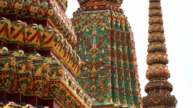 Detailed mosaic artwork on a temple spire