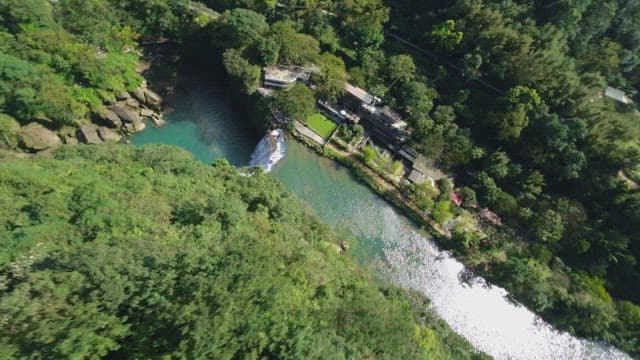 Aerial view of a waterfall and lush forest