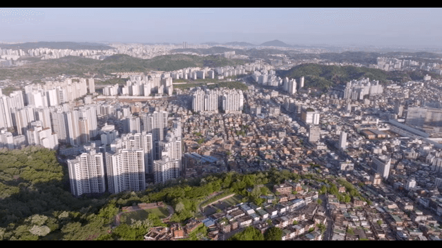 Sprawling cityscape with green hills