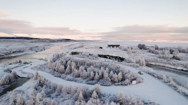 Snowy landscape with river and trees