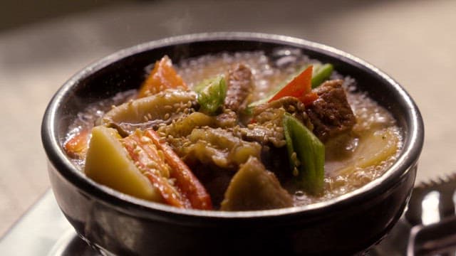 Steaming Galbijjim Served in a Ceramic Stone Bowl