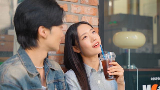 Couple enjoying iced coffee outdoors