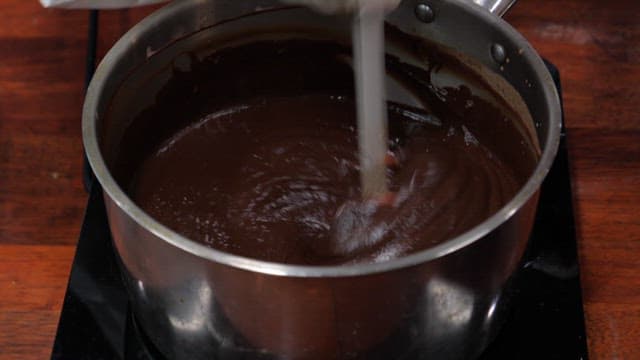 Melting and stirring chocolate in a pot on induction