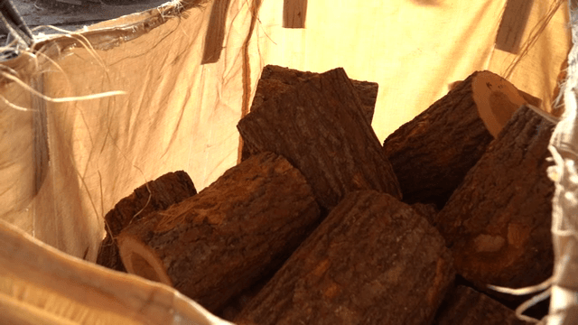 Logs stacked in a burlap sack