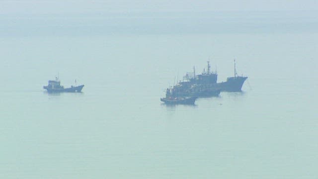Fishing Boats on a Misty Sea