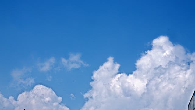 Clear blue sky with white fluffy cloudsin the afternoon
