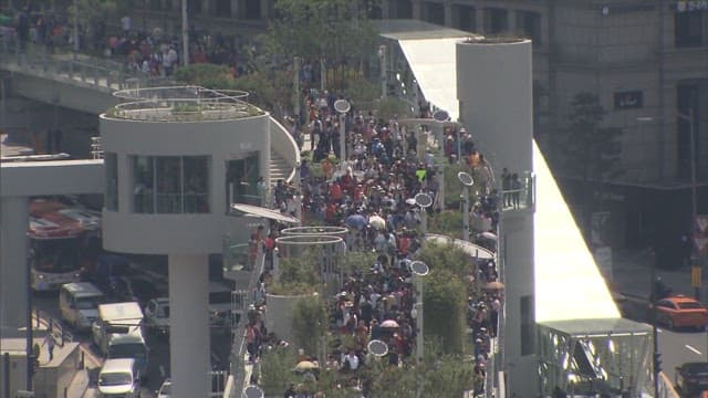 Crowded Urban Park Stairway on Sunny Day