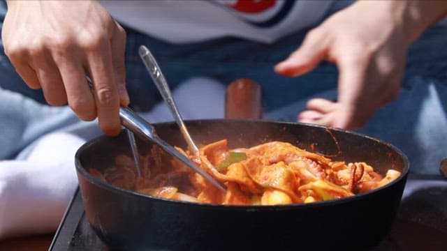 Spicy webfoot octopus tteokbokki is transferred to a bowl