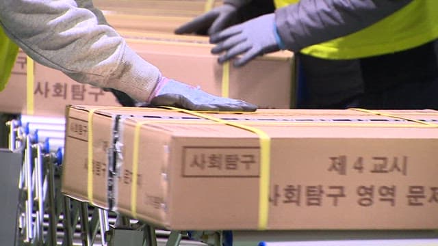 People Moving Boxes of Packed CSAT Question Papers