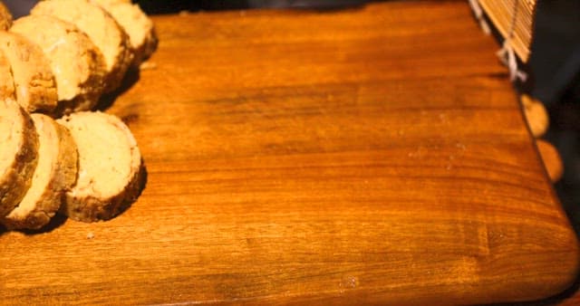 Hand Placing Gridnded Radish on Cutting Board