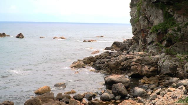 Rocky coastline with a traditional pavilion