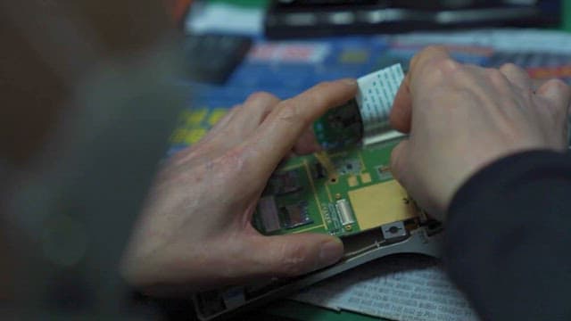 Hands Repairing Electronic Circuit Board