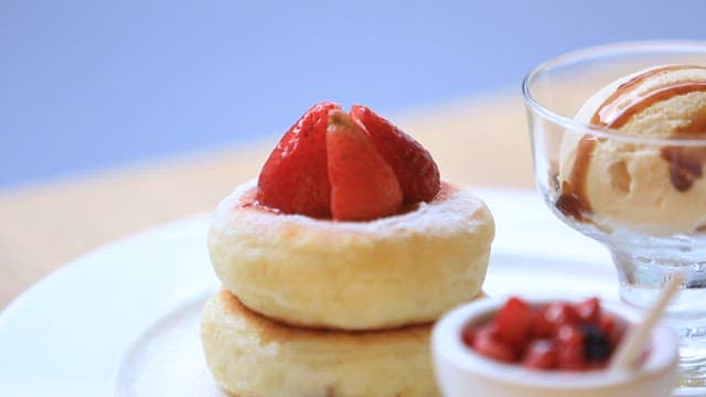 Cutting appetizingly plated griddlecake with sugar filling with a knife