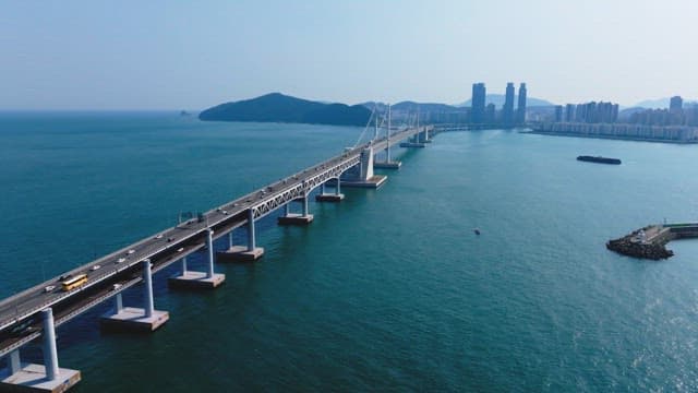 Gwangan Bridge scenery with many cars passing over the blue sea