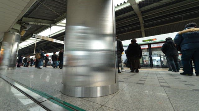 Busy Subway Platform with Many People Coming and Going