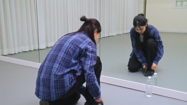 Woman Tying Her Shoes Indoors