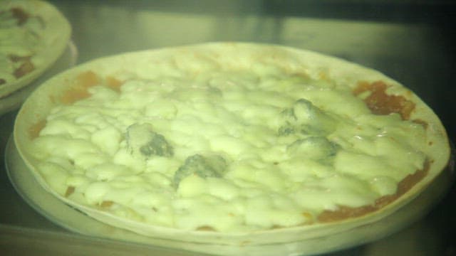 Cheese pizza baking in the oven