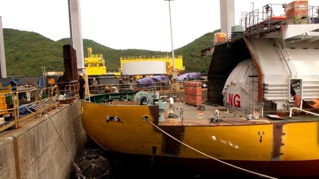 LNG ship docked at an industrial harbor