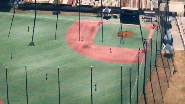 Baseball players practicing on a sunny day
