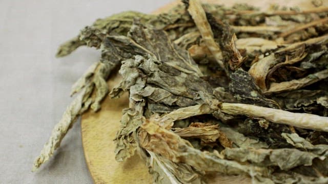 Dried radish greens on wooden board