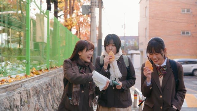 Students eating bungeoppang in winter