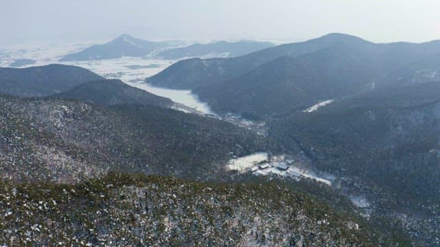 Snow-covered view of a village in the mountains