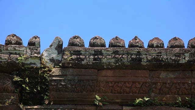 Ancient stone carvings under a clear sky