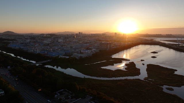 Sunset Over Urban Landscape and Sea