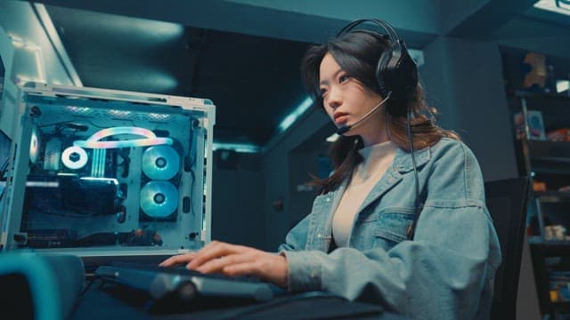 Woman with professional equipments and immersed in gaming