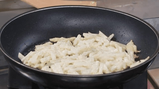 Potato Pancake Being Griddled in an Oiled Frying Pan