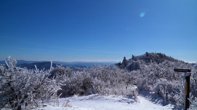 View from a snow-covered mountaintop on a sunny winter day