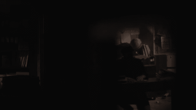 Silhouetted Man Contemplating in a Dark Office