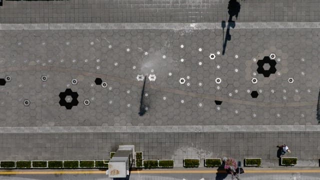 Fountain by Pedestrian in the City on a Sunny Day