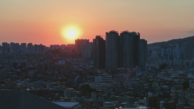 Sunset over a bustling city skyline