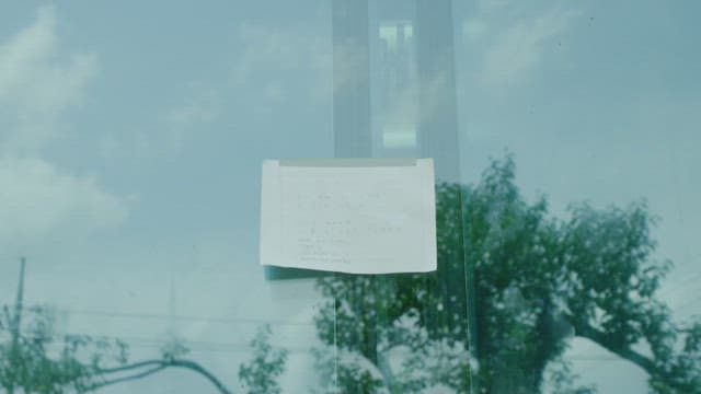 People attaching post-it notes on windows