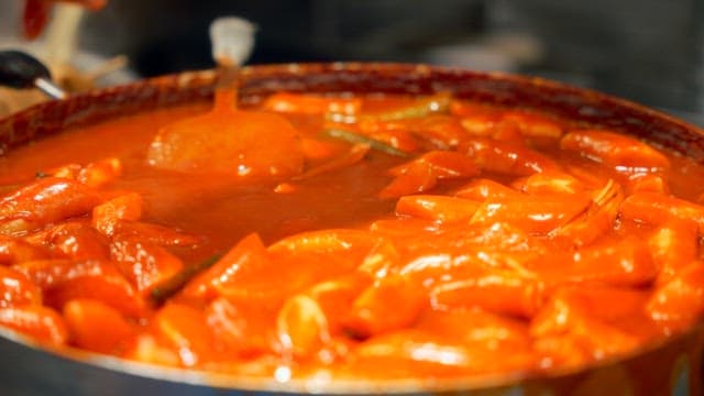 Tteokbokki simmering in a large pan
