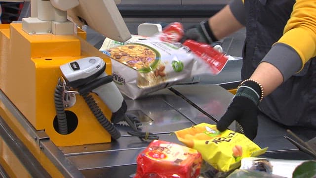 Clerk Scanning the Barcode of Products at the Checkout Counter