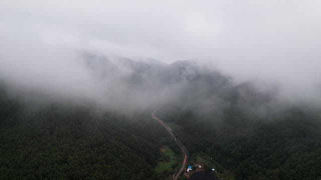 Misty mountains with a winding road