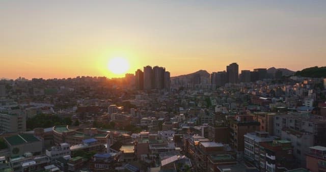 Sunset over a bustling city skyline