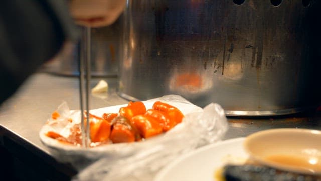 Man eating Korean street food Tteokbokki