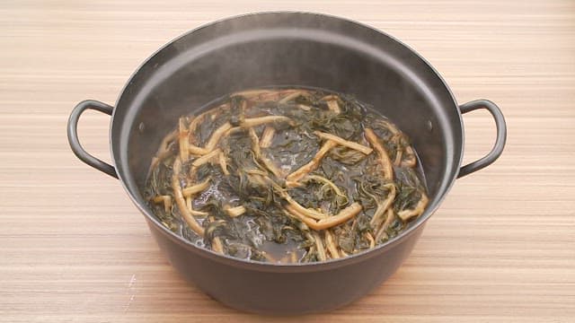 Hot dried radish greens soup in a pot on the table